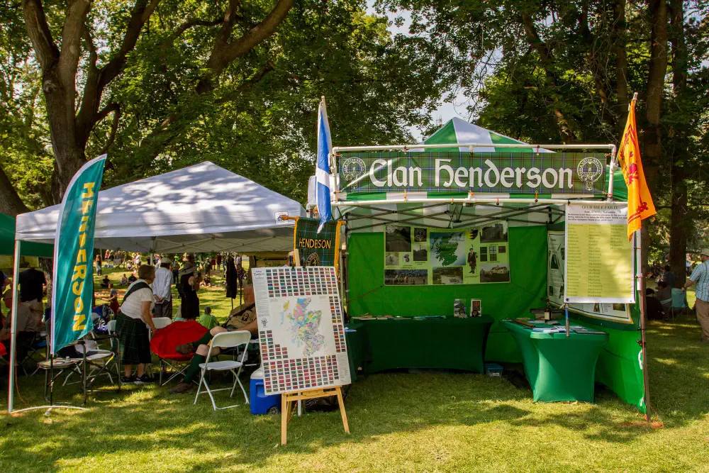 Clan Henderson tent with tartan and family-history displays at the gathering.