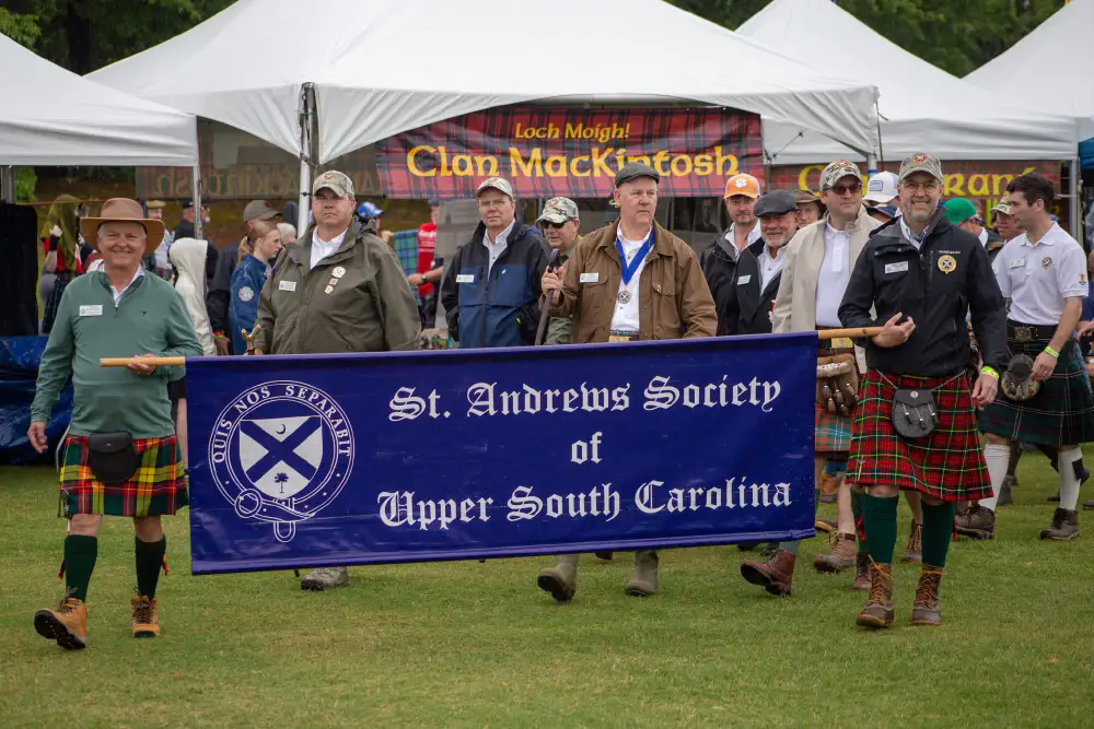 Participants carrying the St. Andrews Society of Upper South Carolina banner