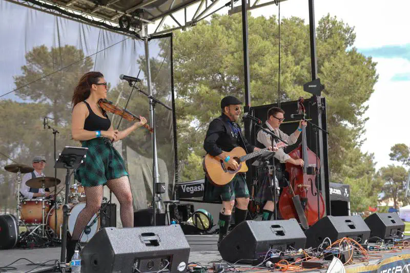 Musicians performing on an outdoor festival stage