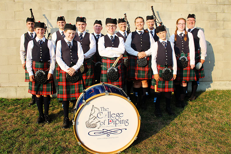 College of Piping Pipe Band members with their bass drum