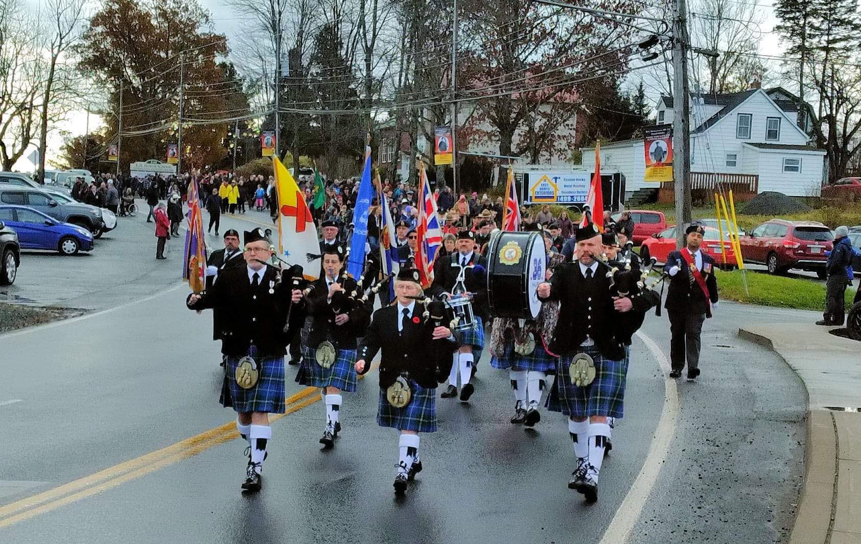 New Scotland Pipes and Drums marching in a community parade
