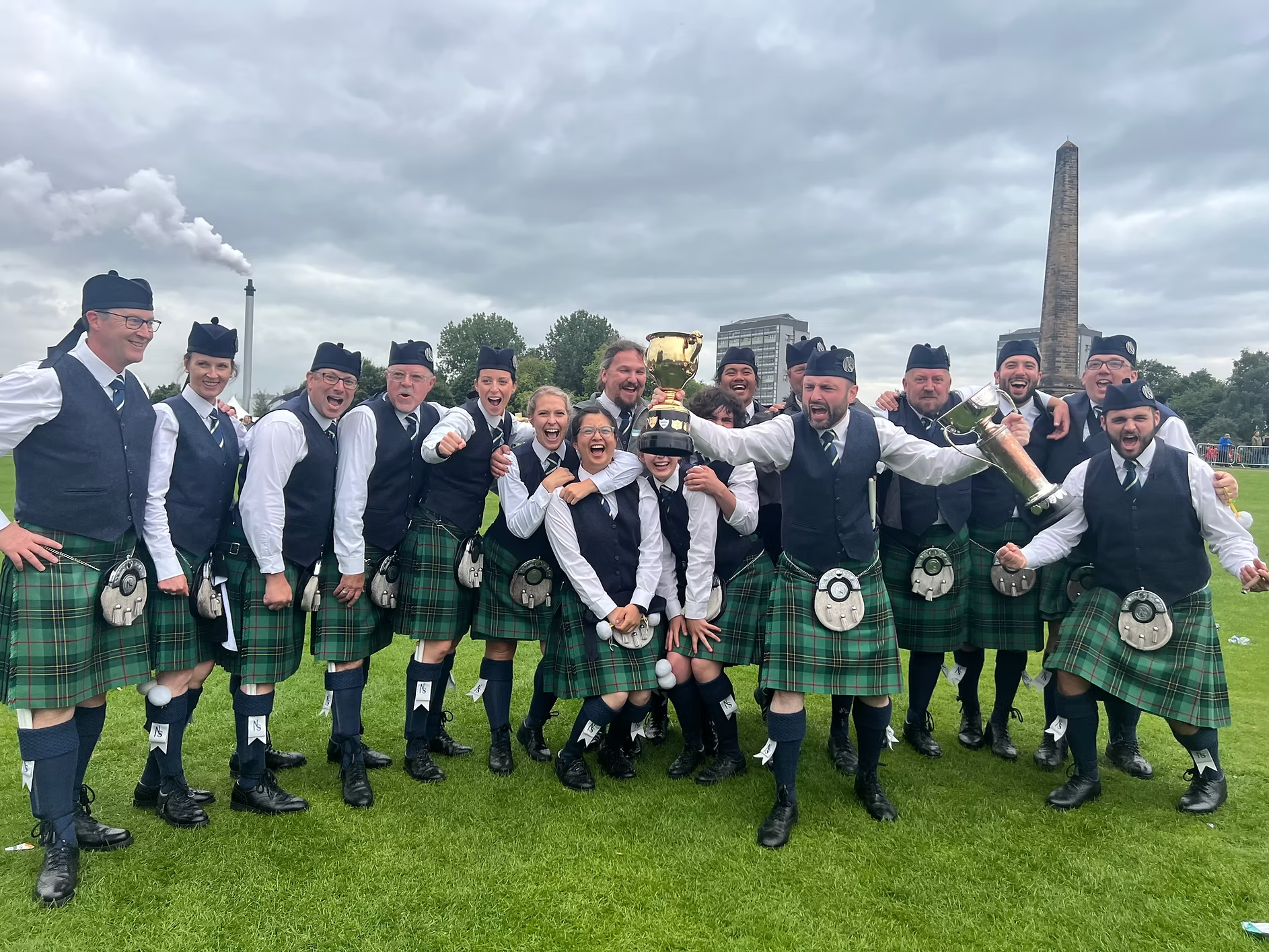 North Stratton Pipe Band members celebrating with trophies